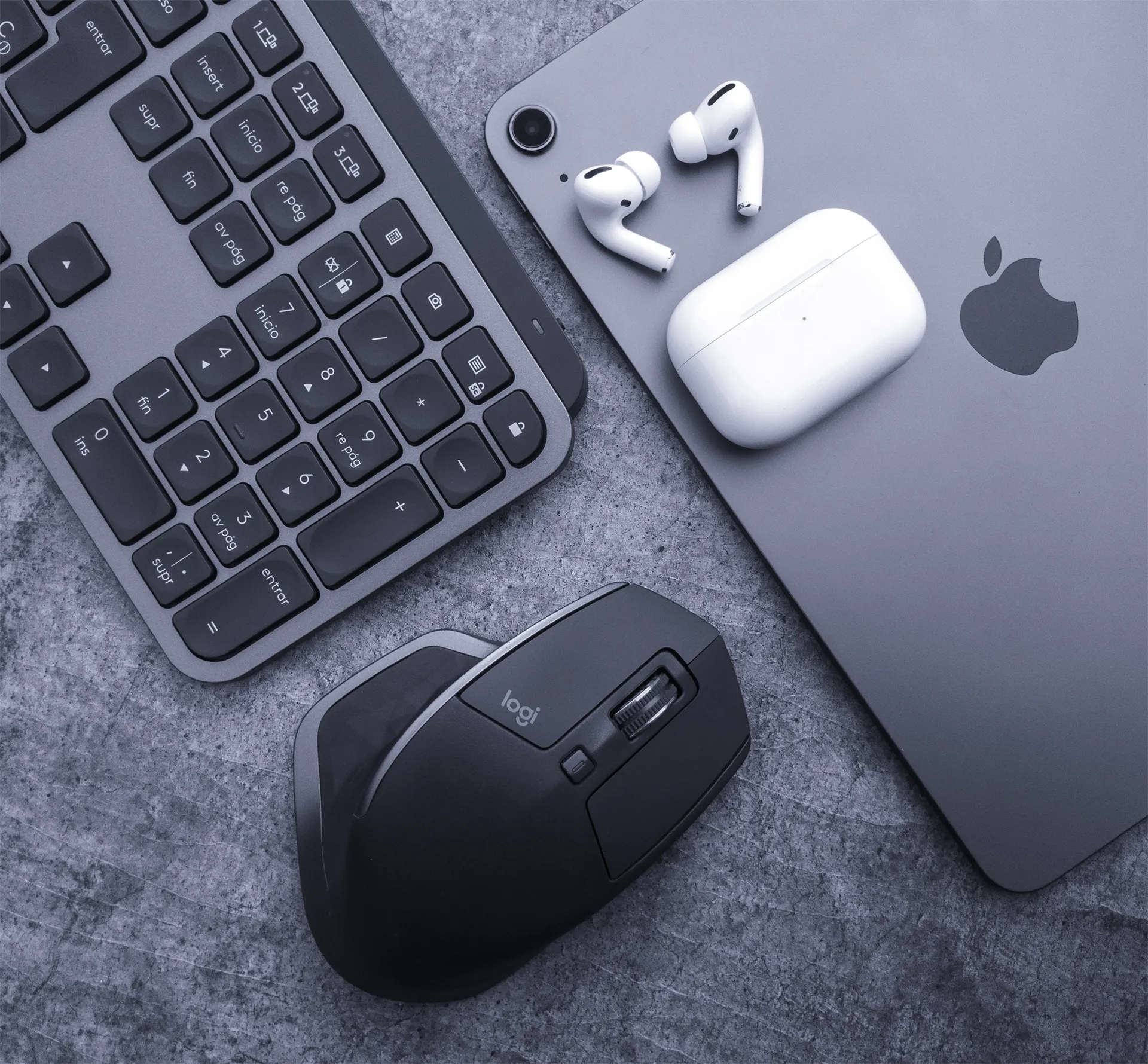 Apple and logi products on a concrete surface