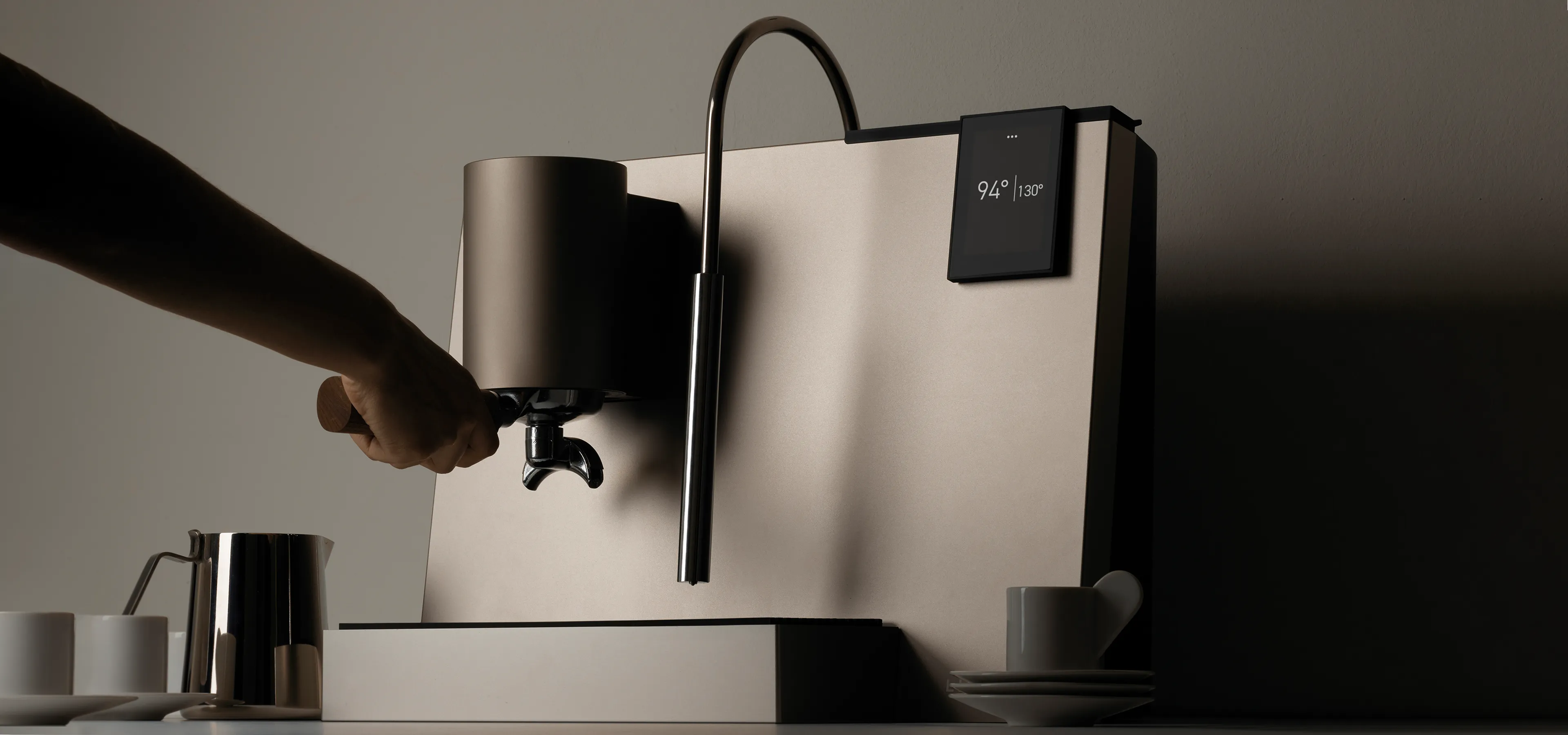 Modern coffee espresso machine with a hand on the porta filter