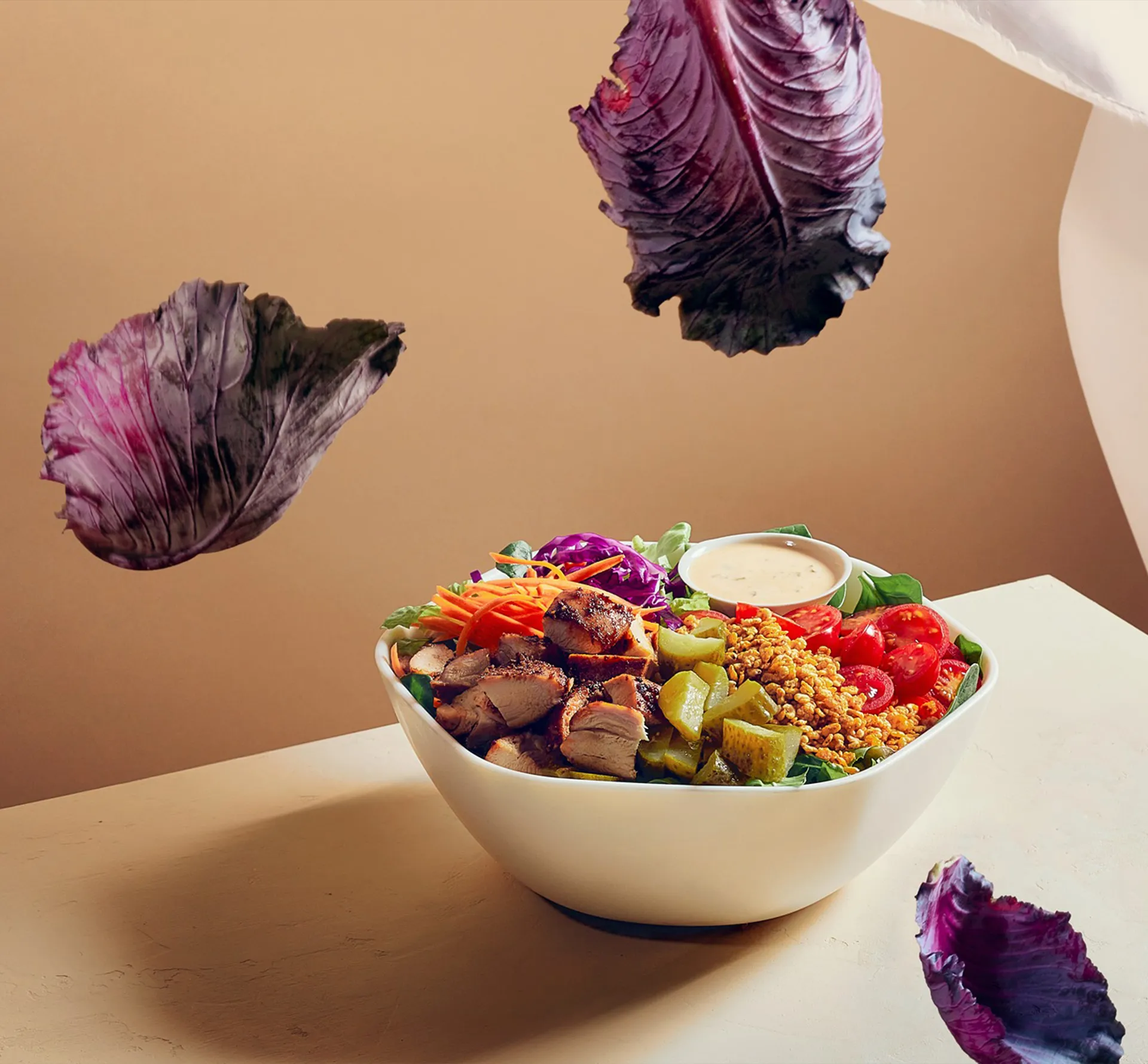 a healthy bowl of salad with falling red cabbage leaves