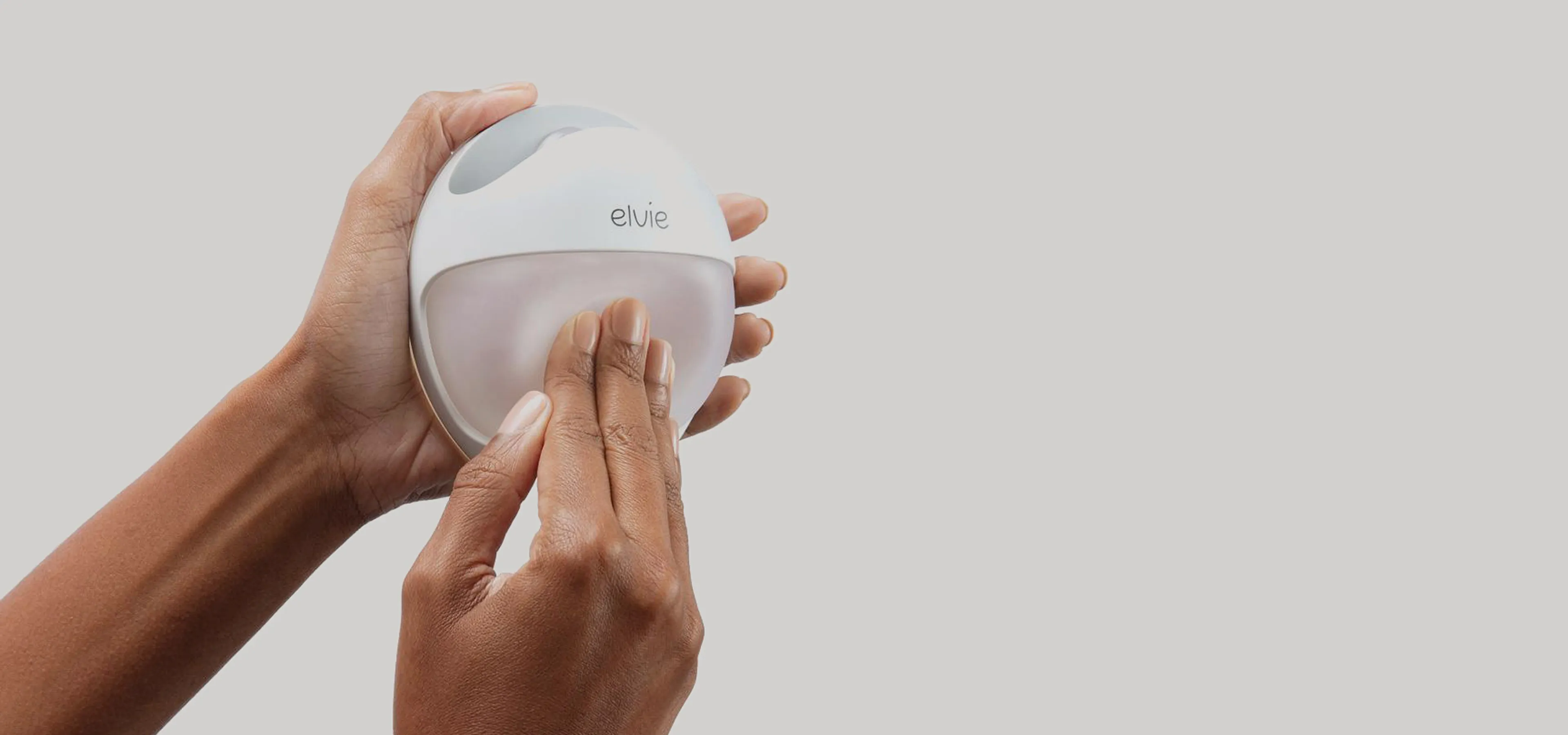 Elvie curve in hands being primed with a press