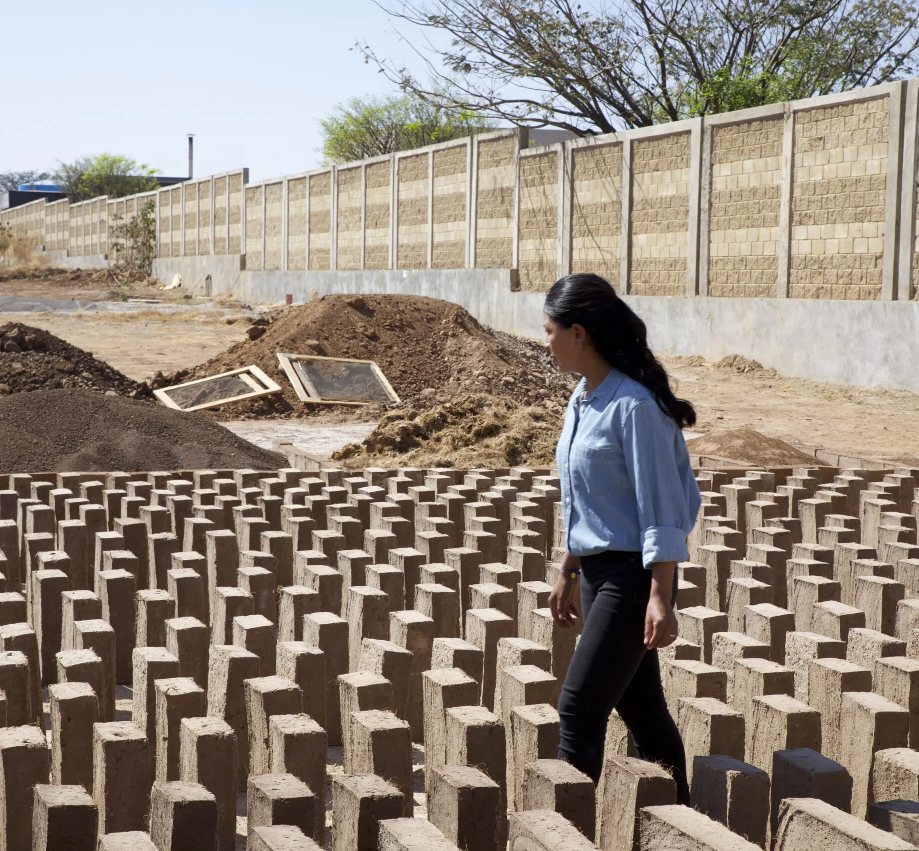 Martha Jimenez Cardoso surveying the Adobe blocks drying in the sun