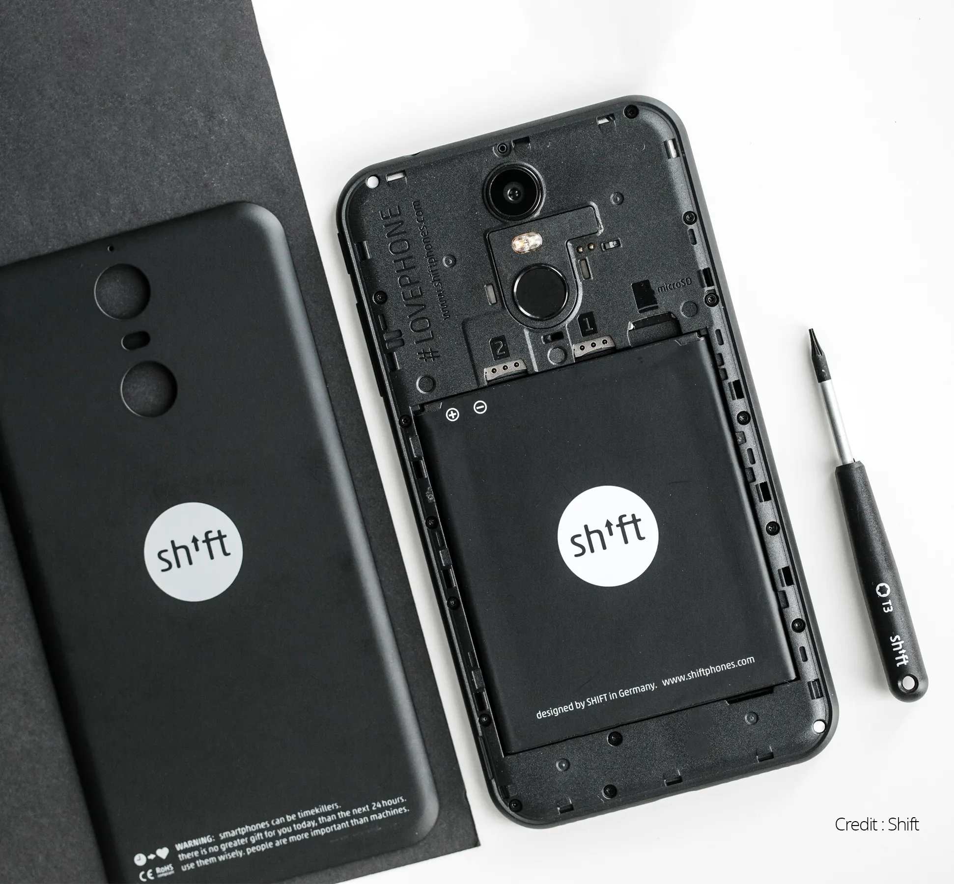 A black shift phone being opened up to change the battery