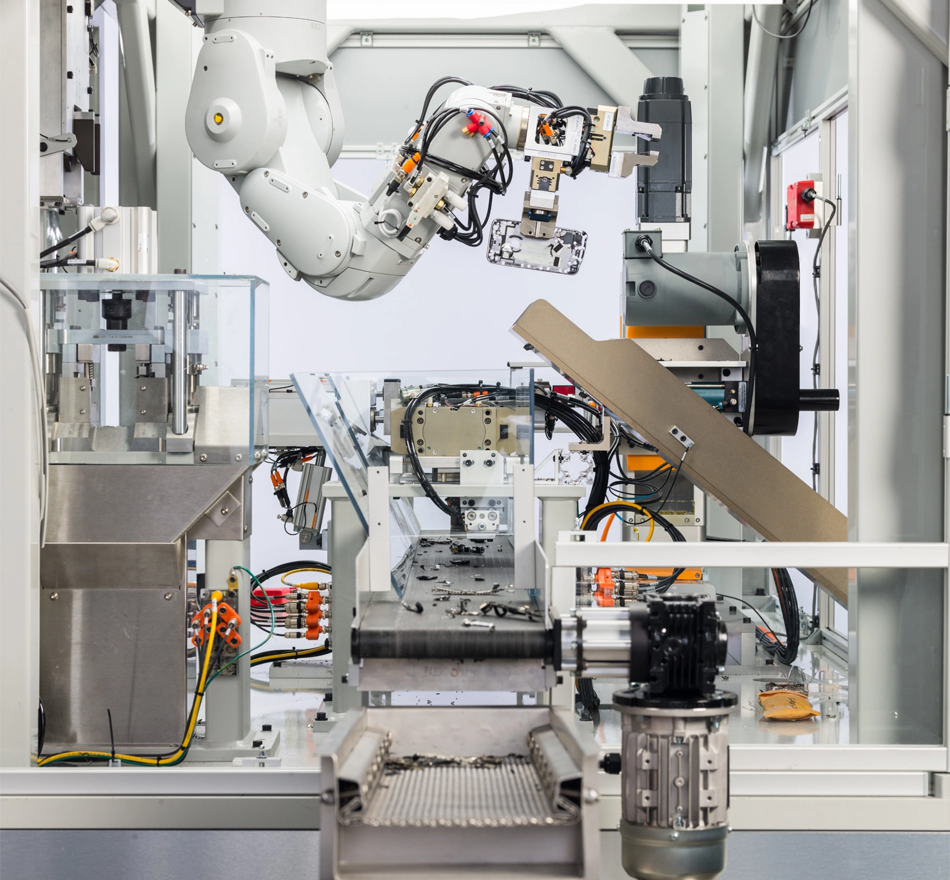 A robotic arm disassembling an iPhone