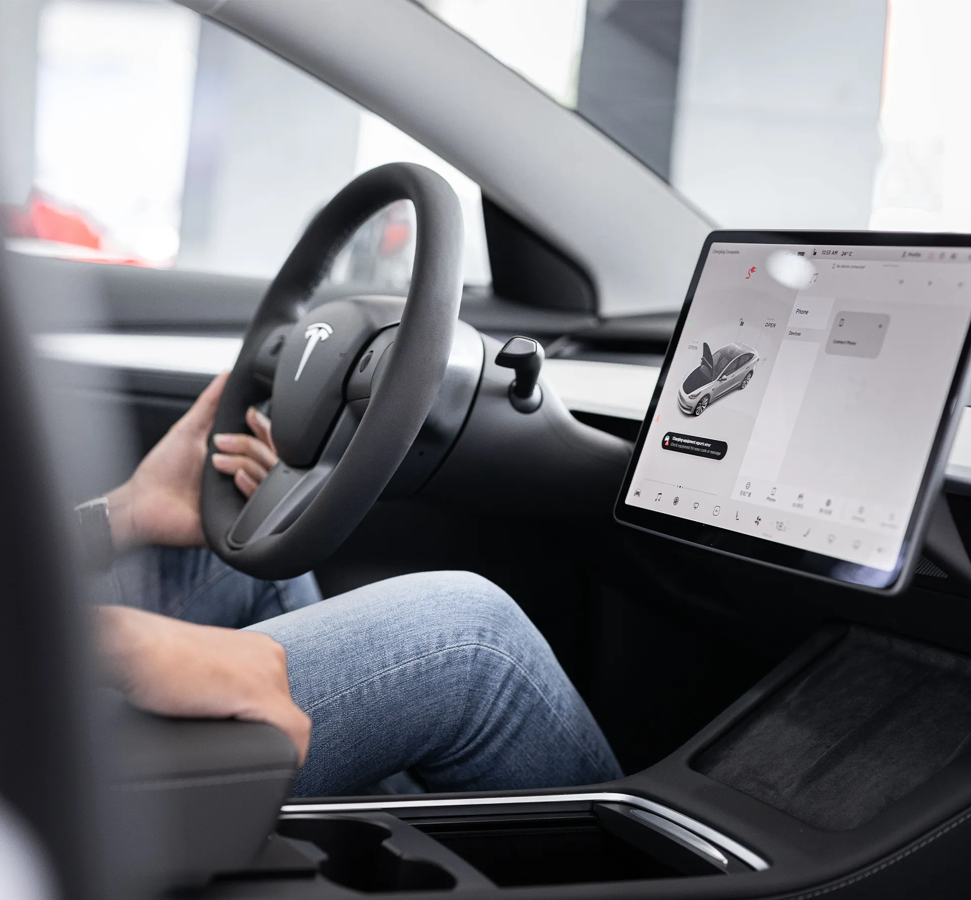 Interior shot of a Tesla with driver