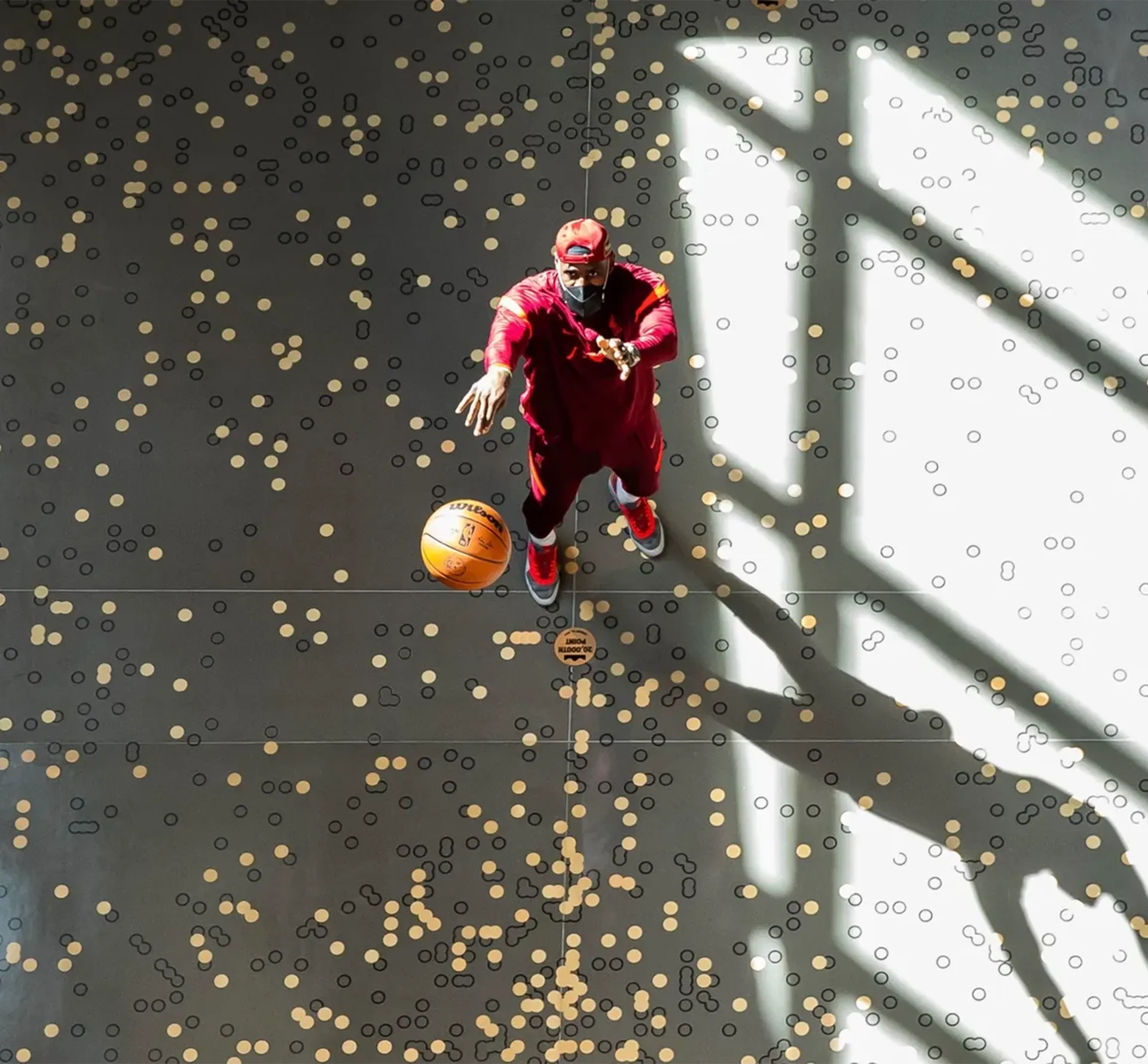 Basket ball player taking a shot viewed from above