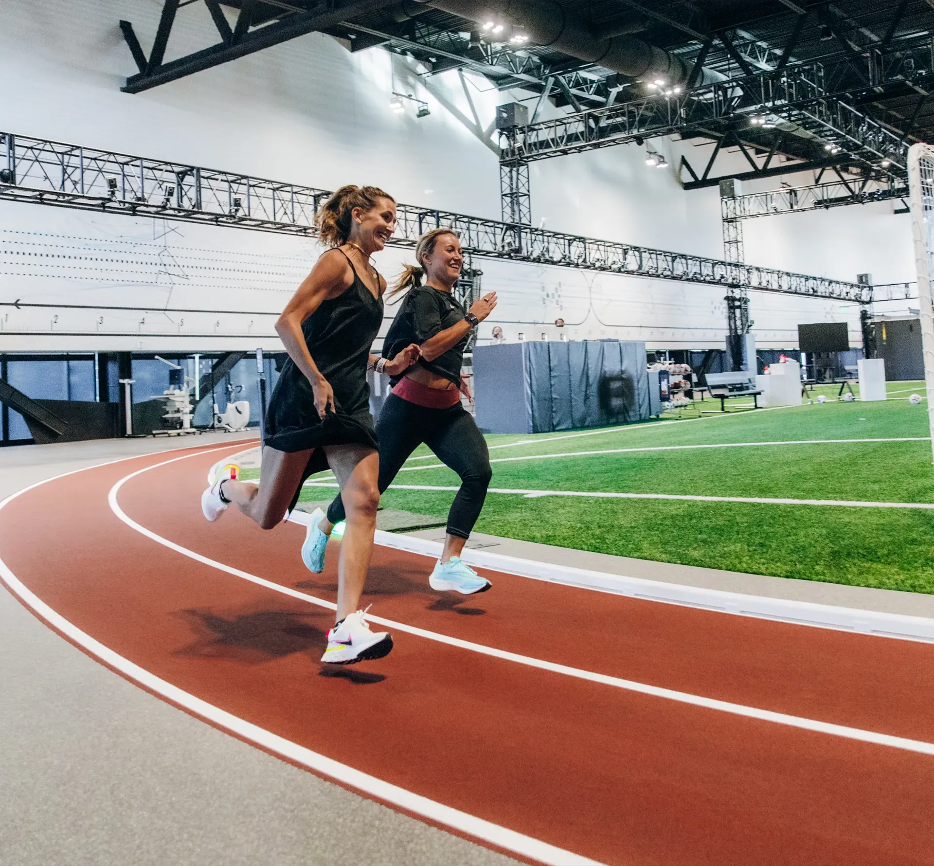 Women running on an indoor racetrack
