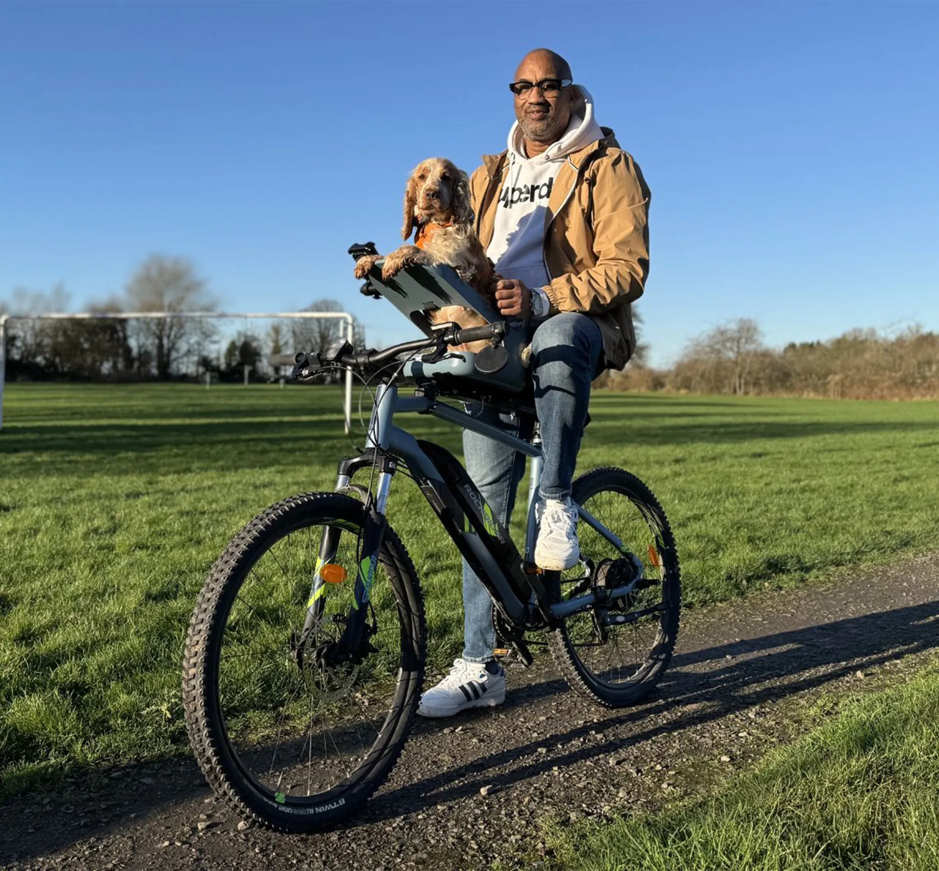 Owner riding with pet in a dog seat attached to a bike