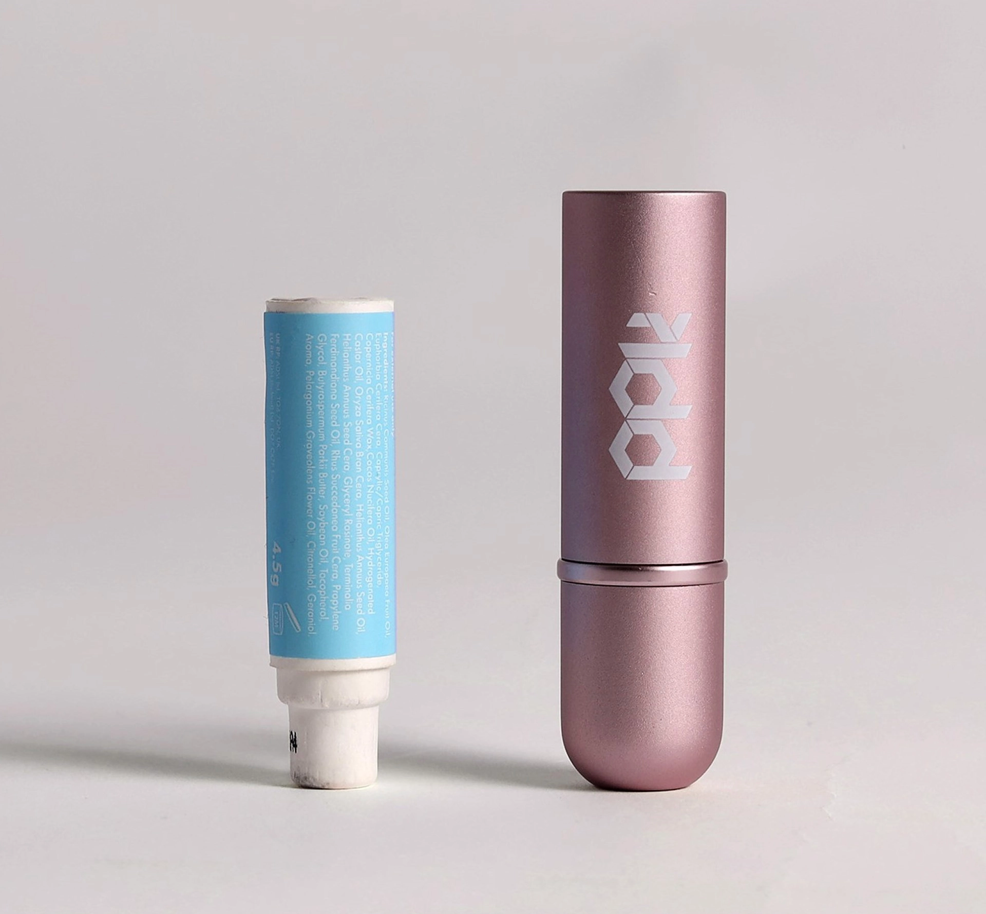 Lipstick and case against a grey background
