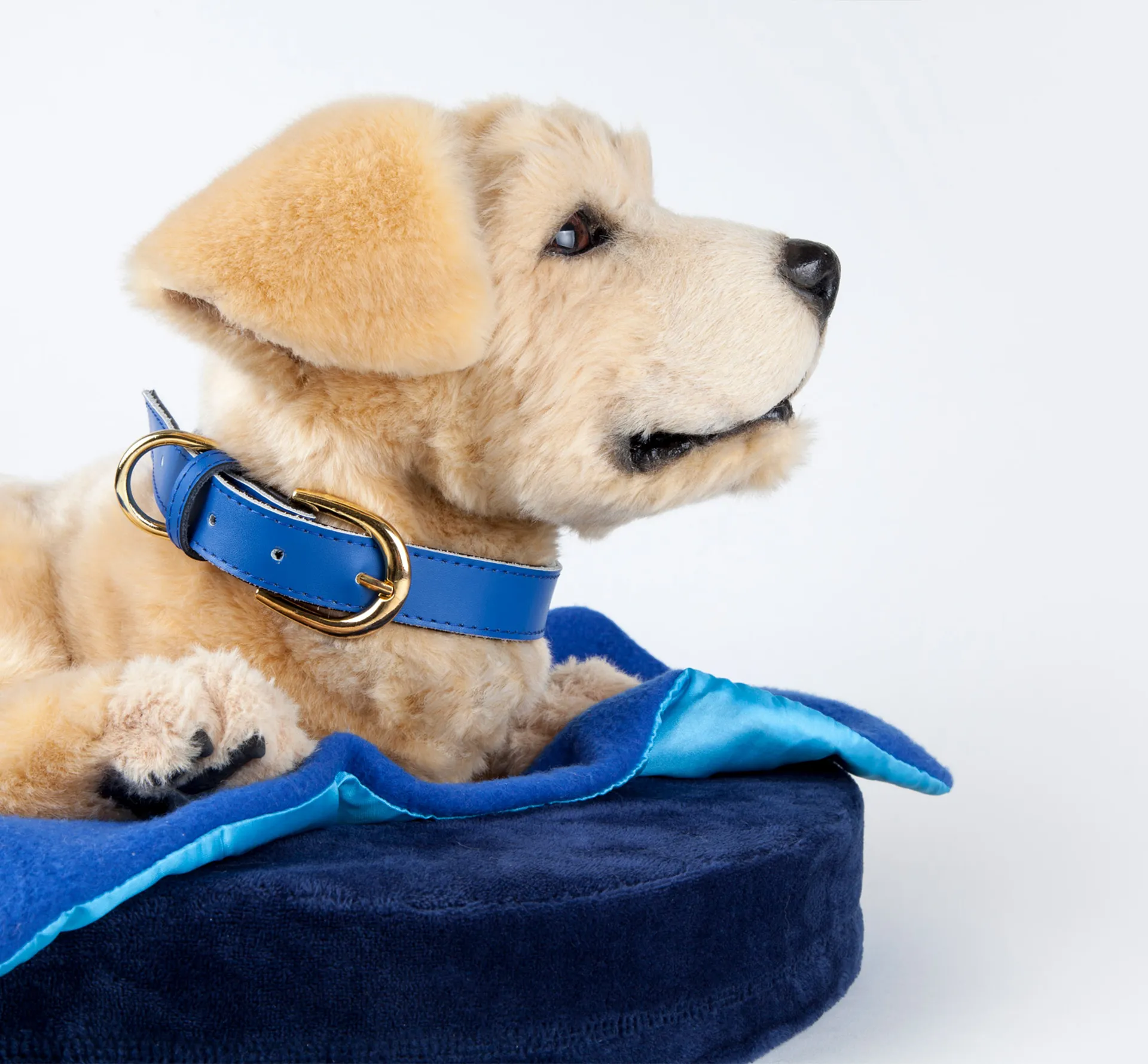 Small realistic robot dog in it's bed