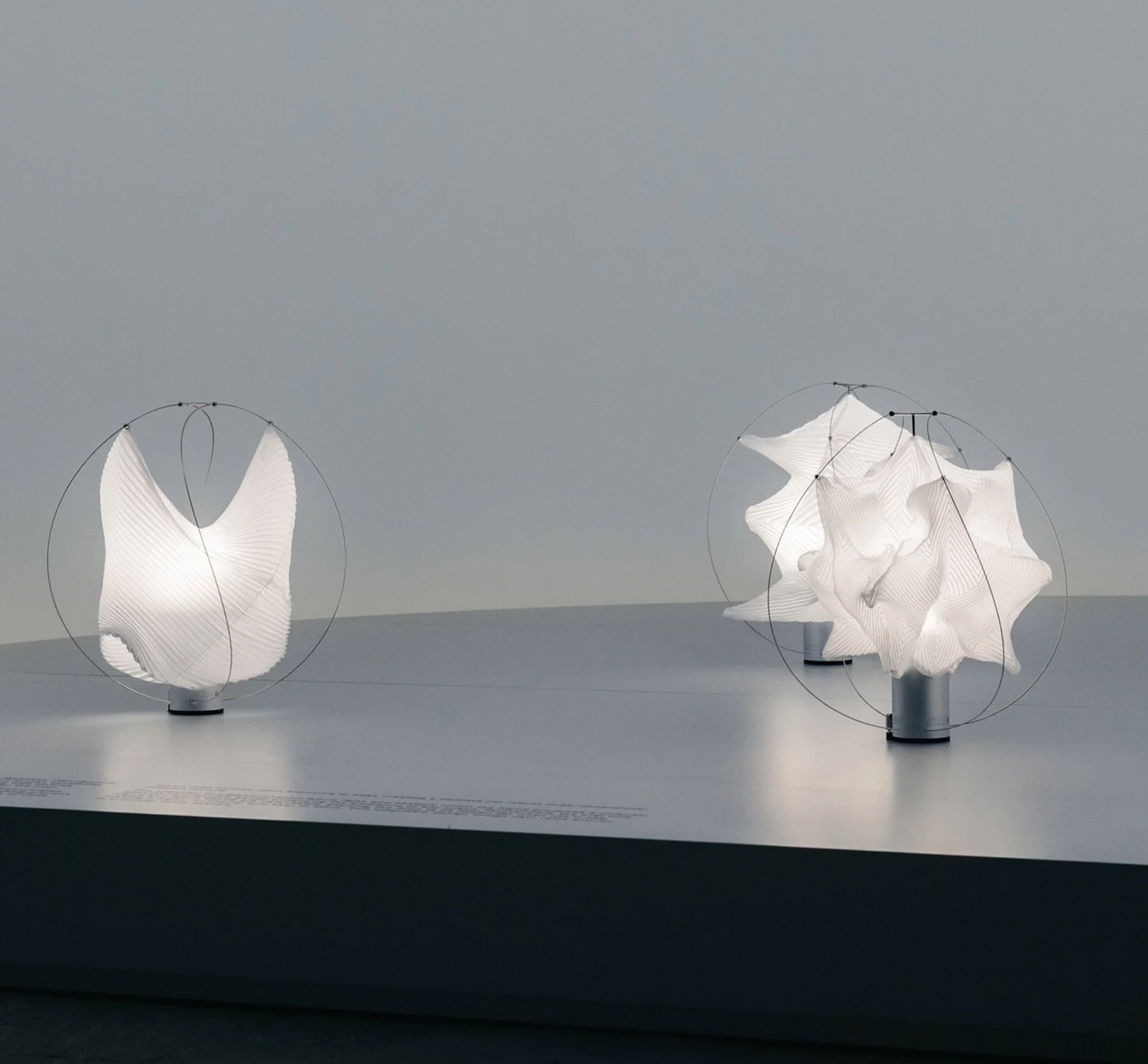 White cloth sculptural objects on a grey plinth