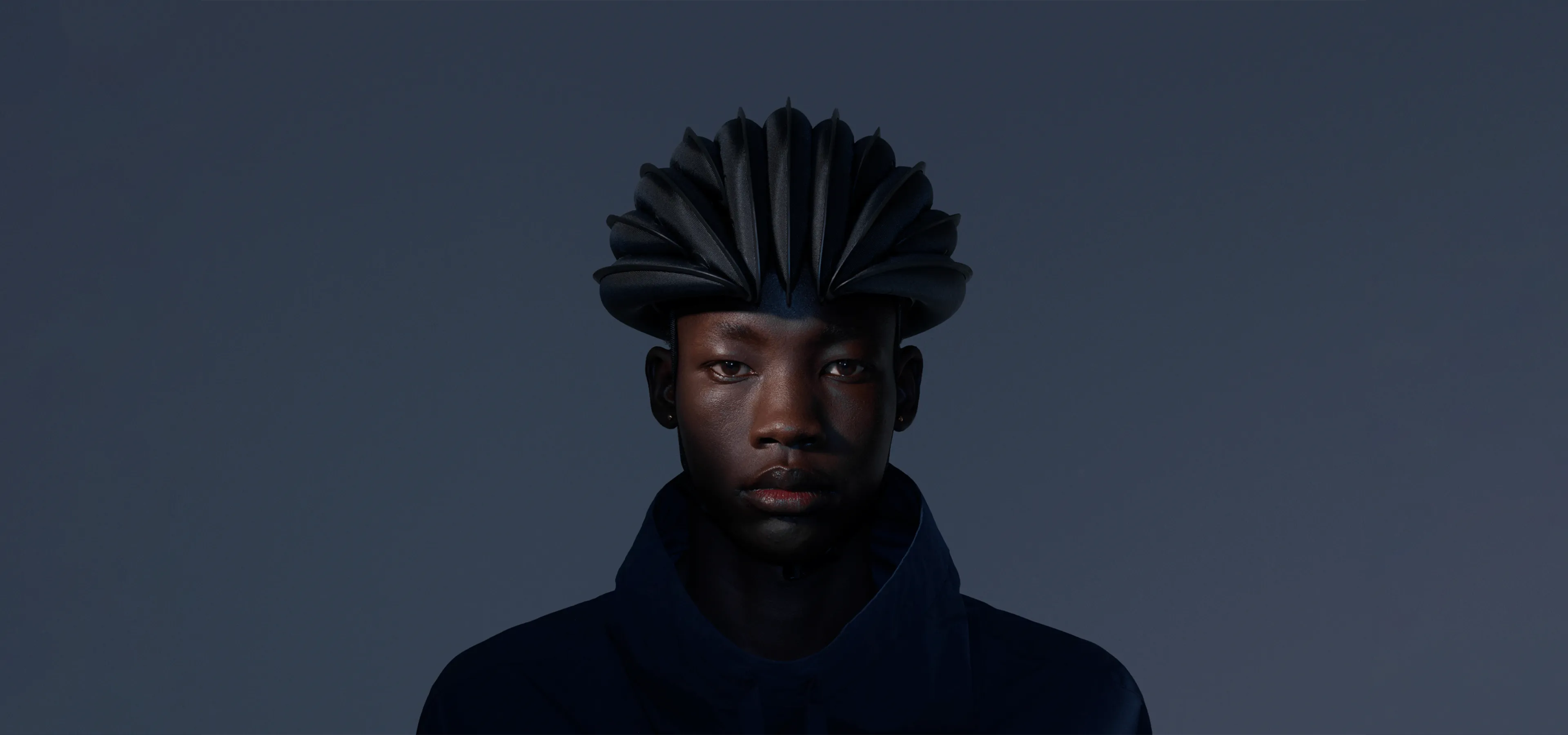 Dark image of a person with bike helmet on