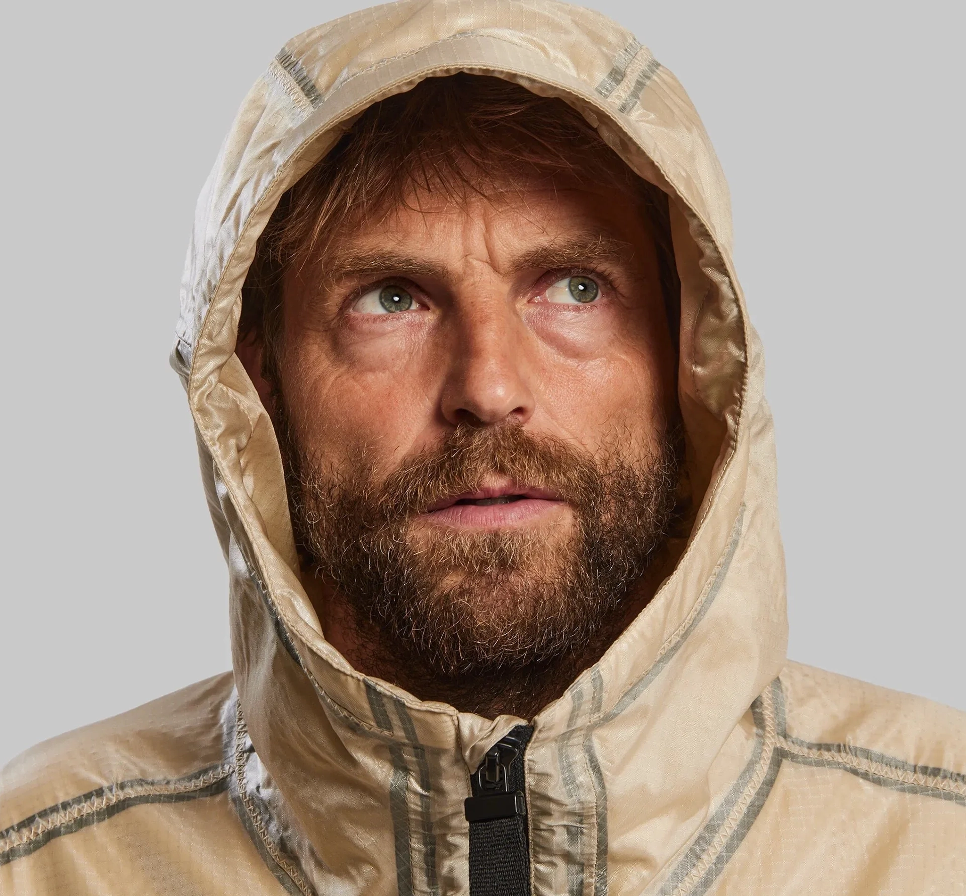 Man in a hooded jacket looking up