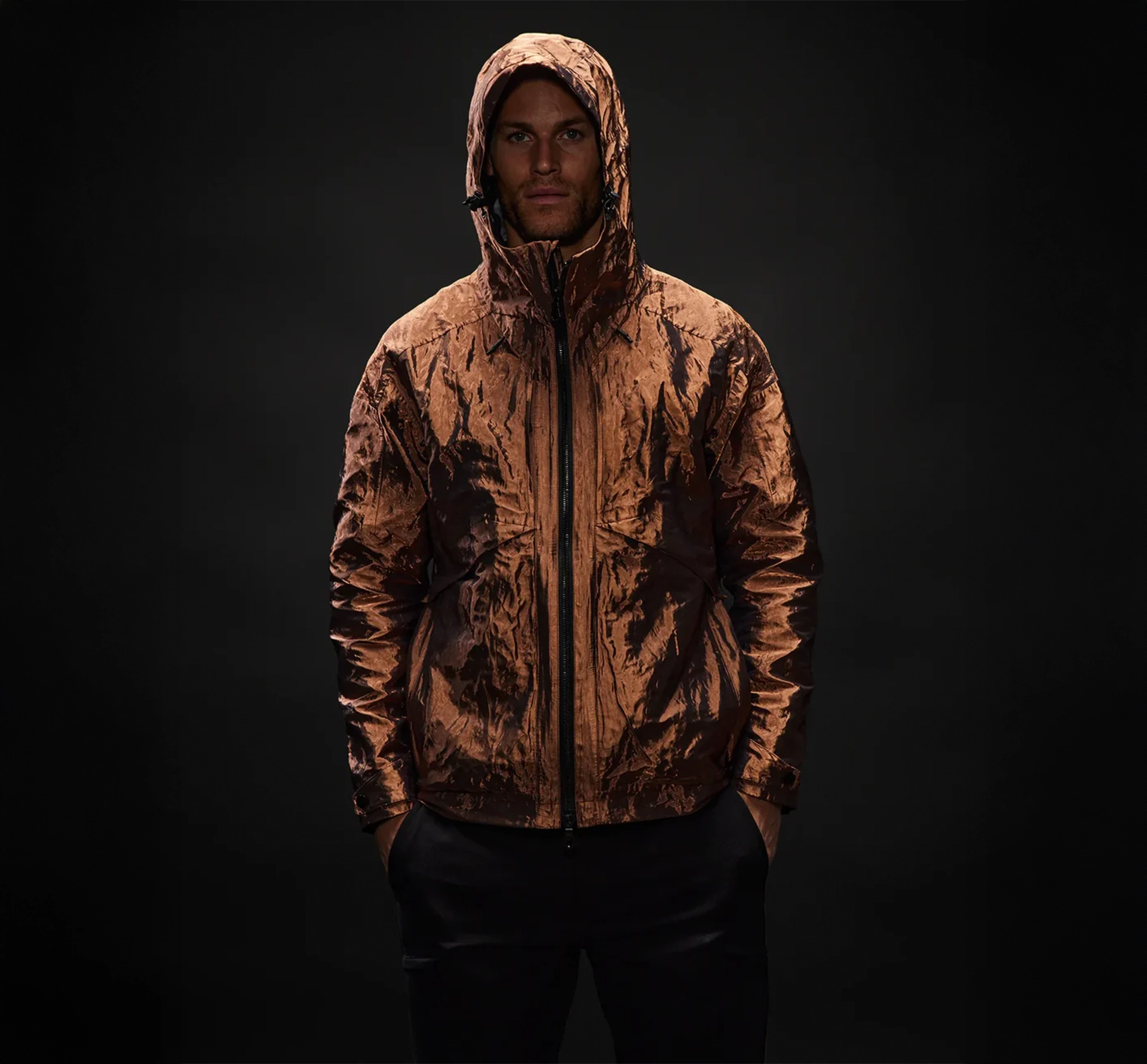 Man in a hooded copper coloured jacket