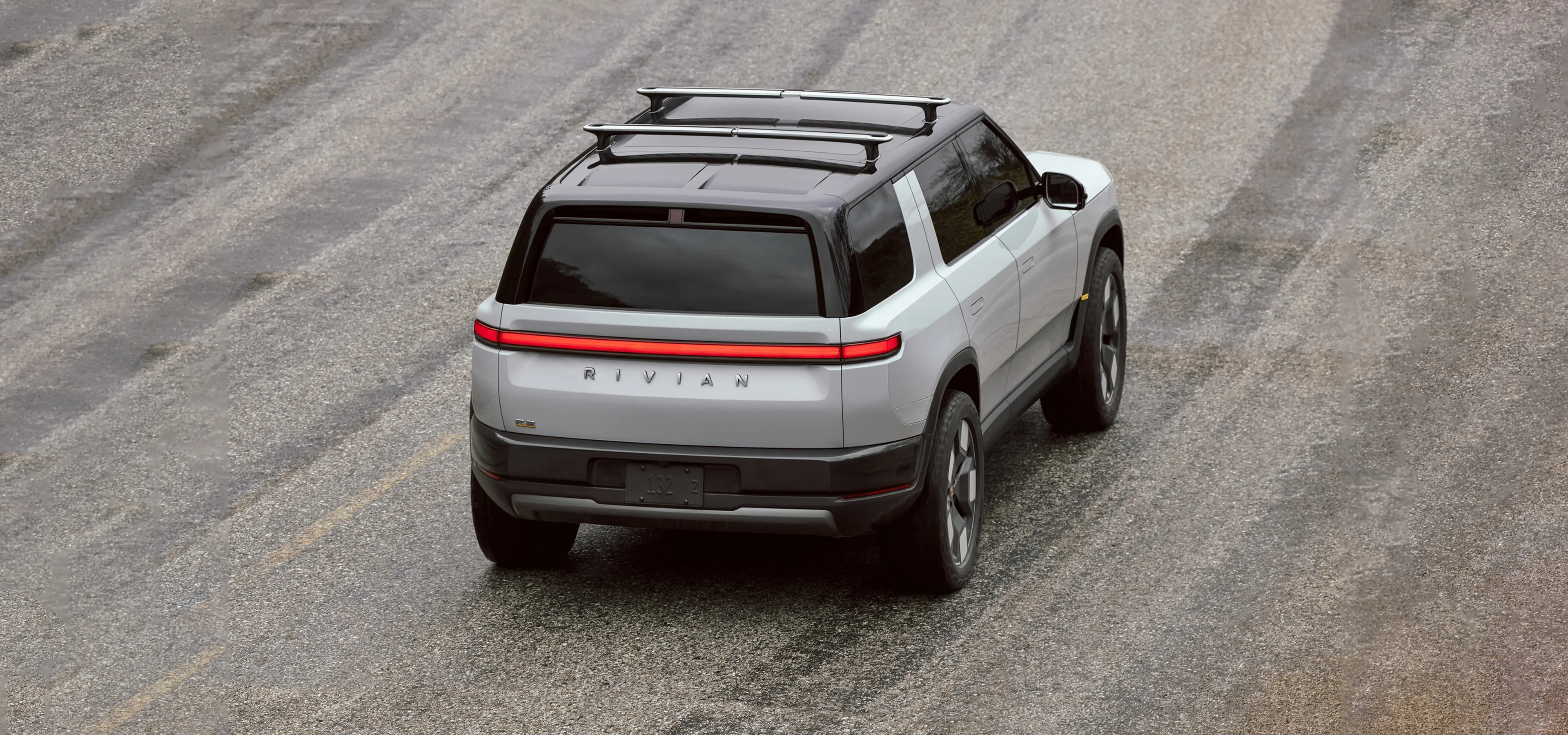 Rivian electric car driving on a wide road