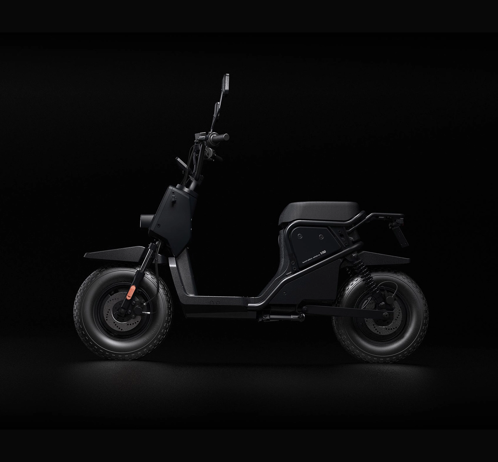 Side view of a black electric scooter