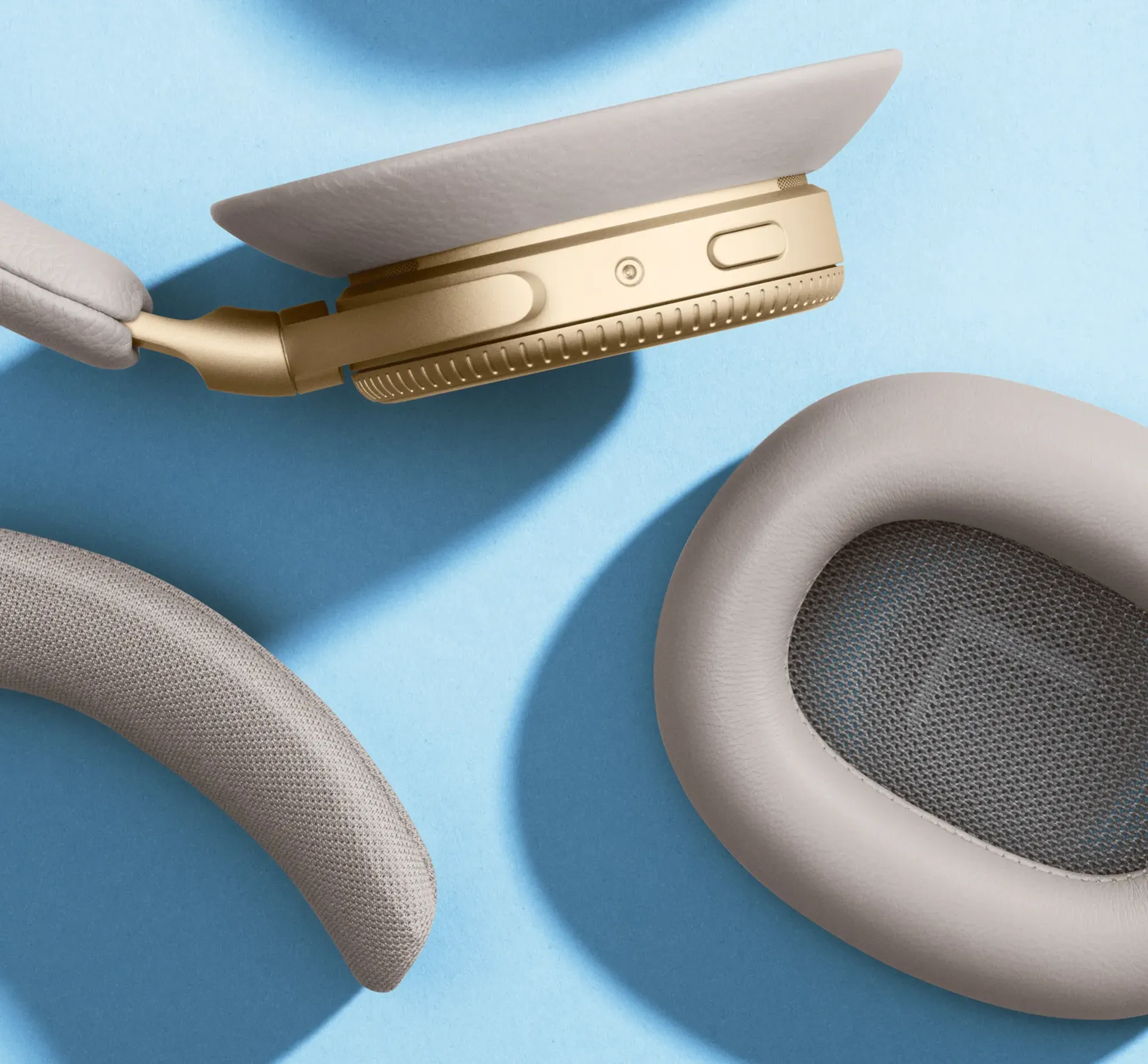 Bang&Olufsen headphone in separate pieces on blue background