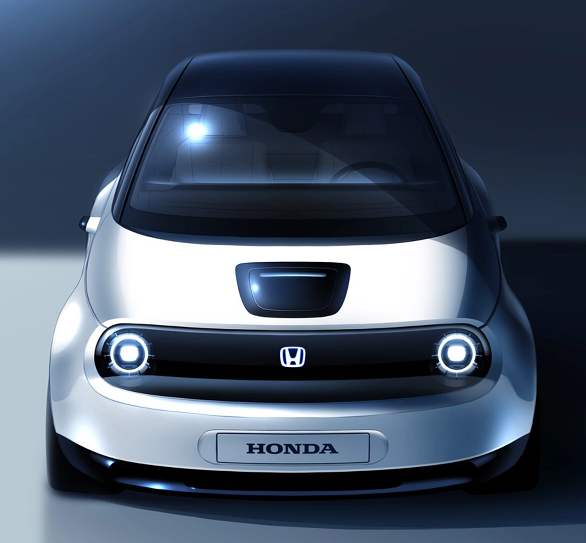 Front view of a Honda small white electric car