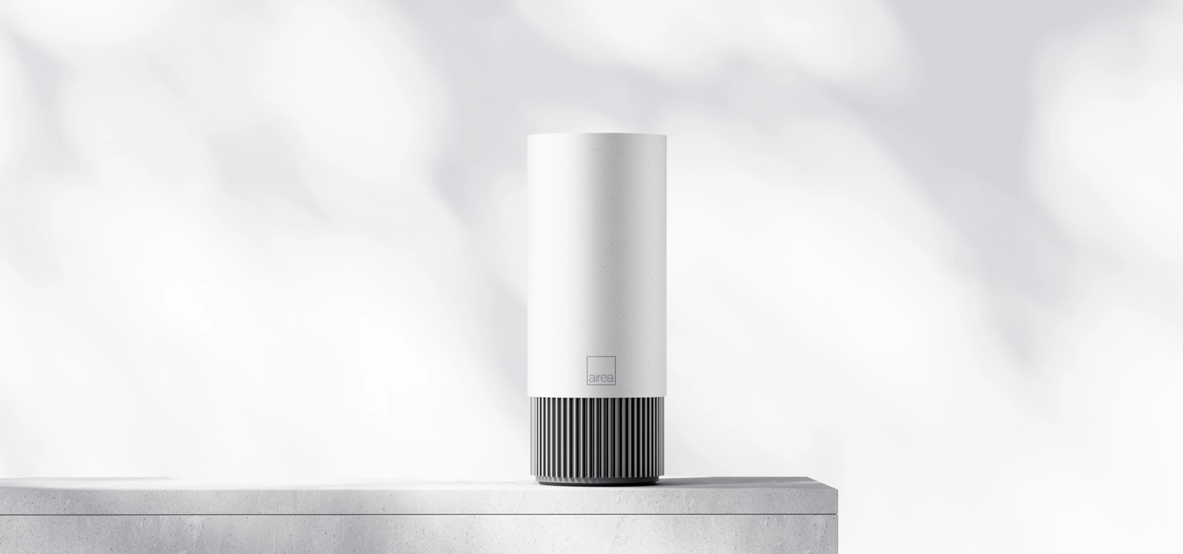 White air purifier on a table with shadows in the background