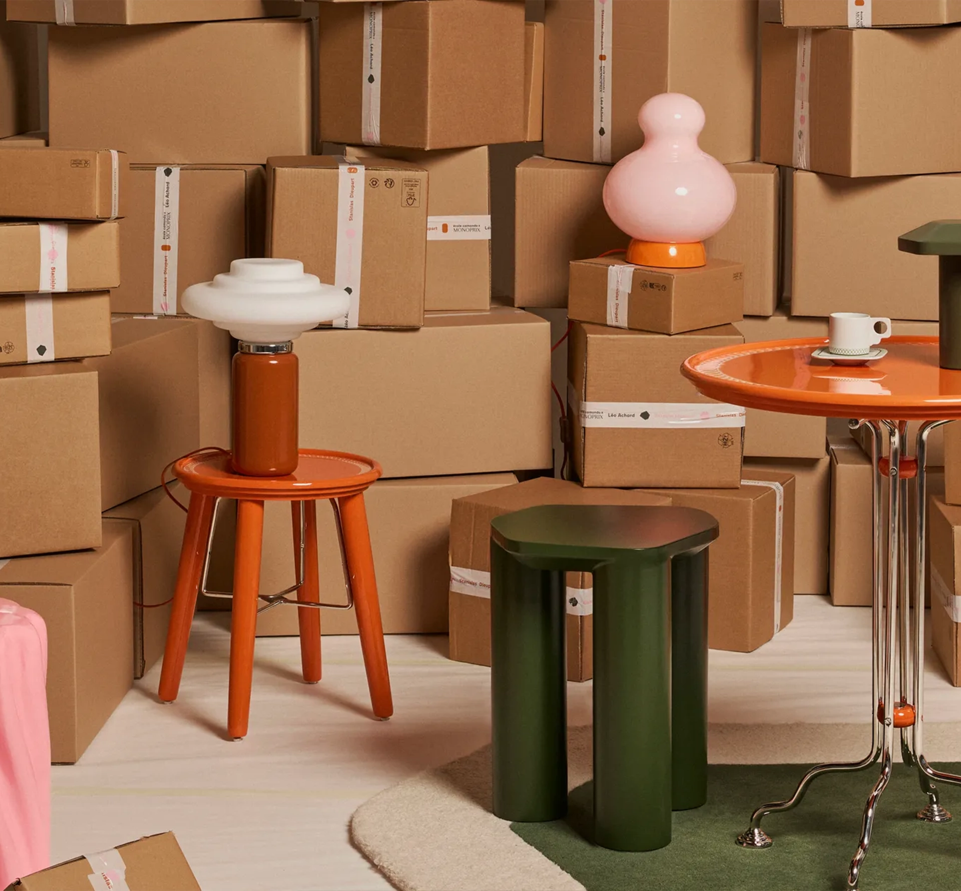 Colourful stools and table with cardboard boxes in the background