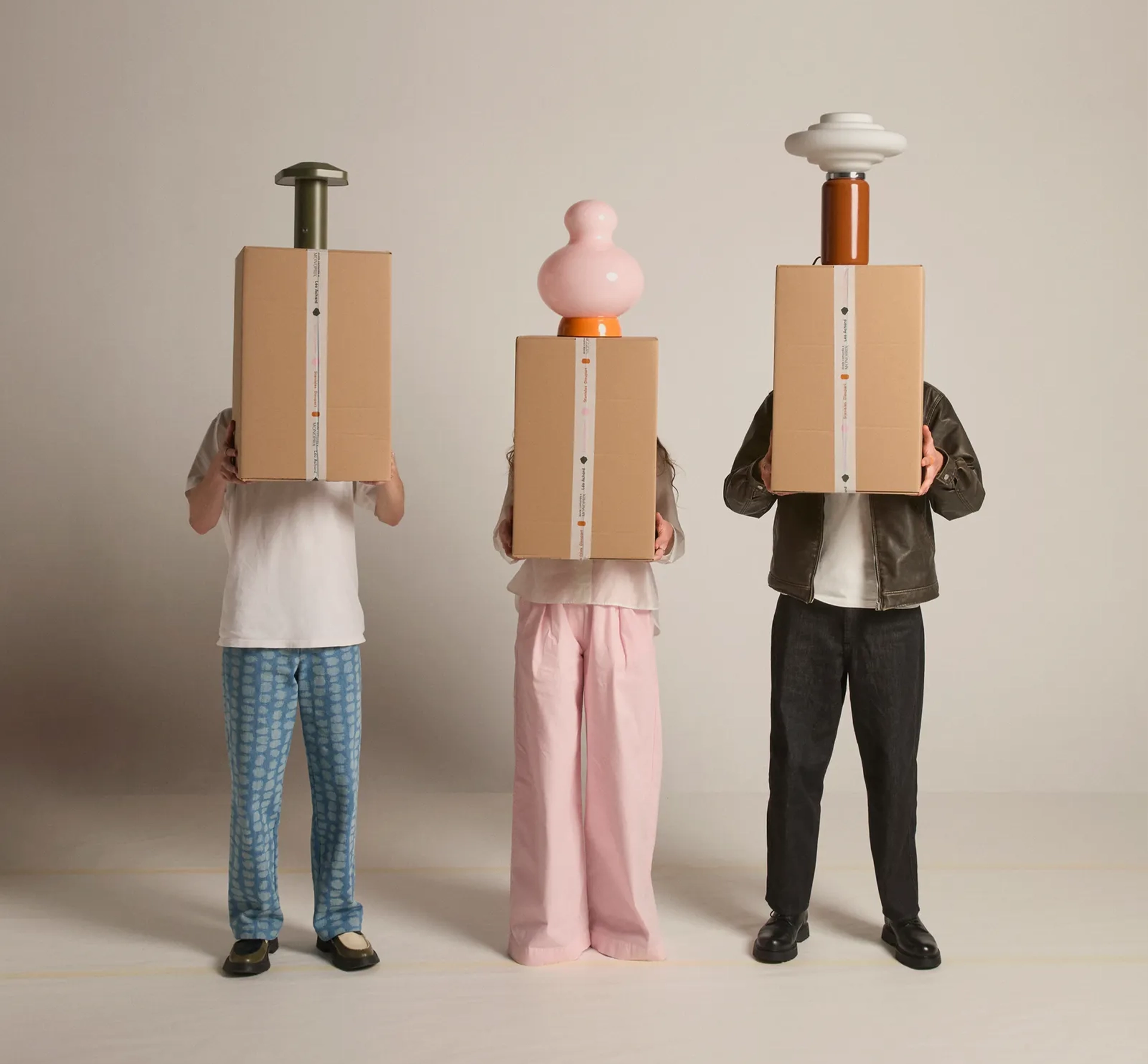 People holding boxes with colourful lamps ontop