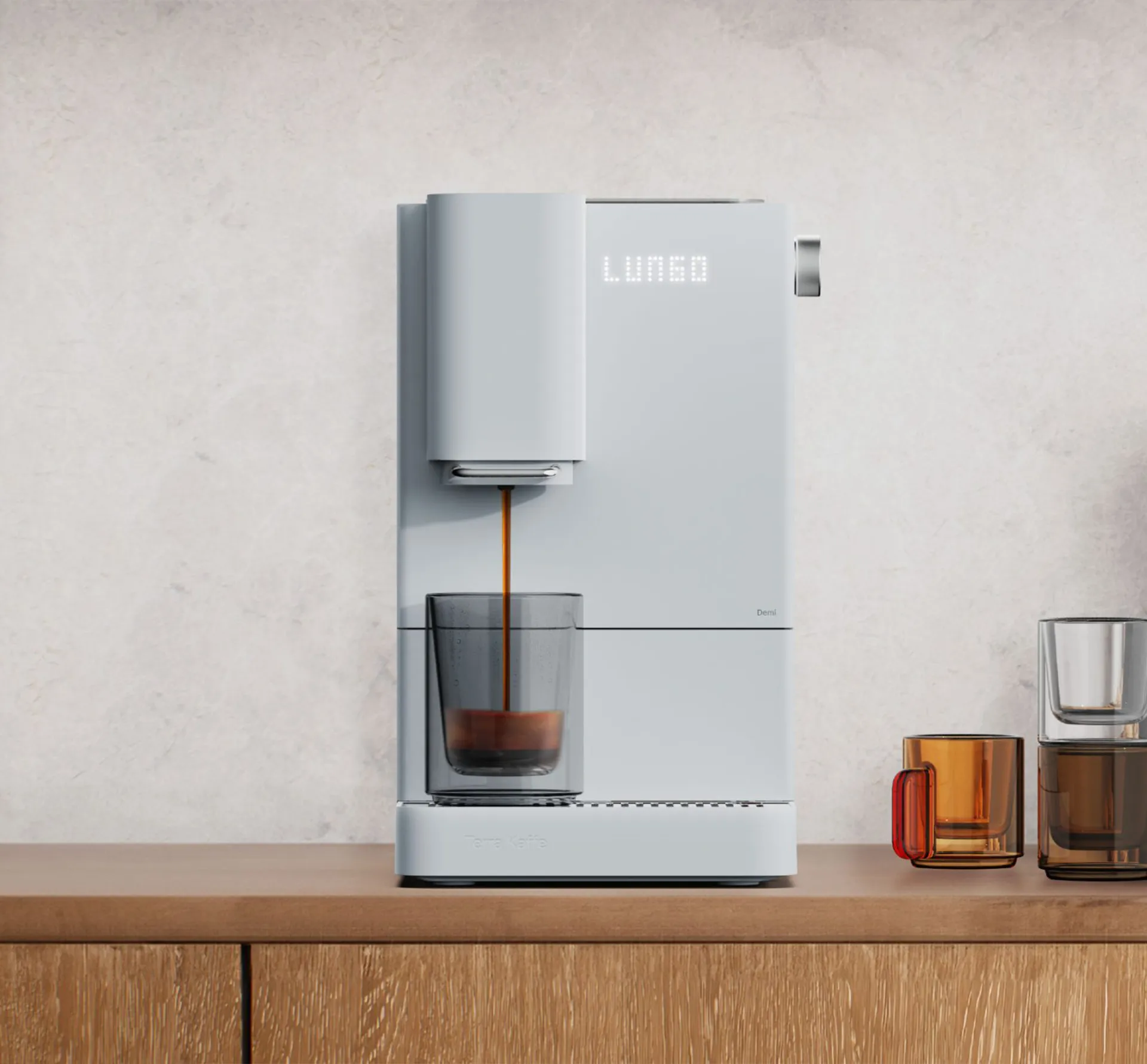 White coffee machine filling a cup on a wooden cabinet