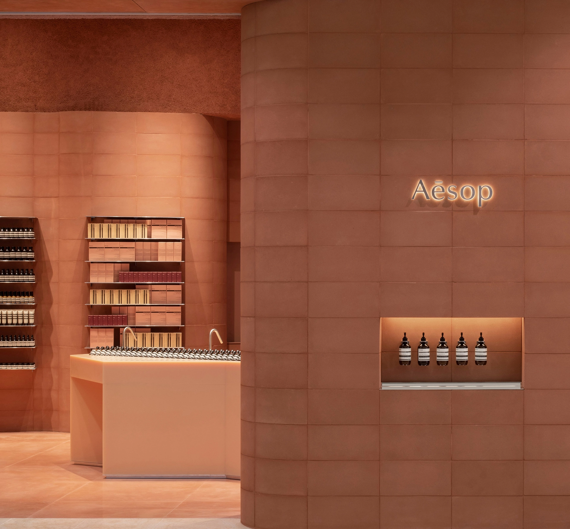 Inside an Aesop store in terracotta colour