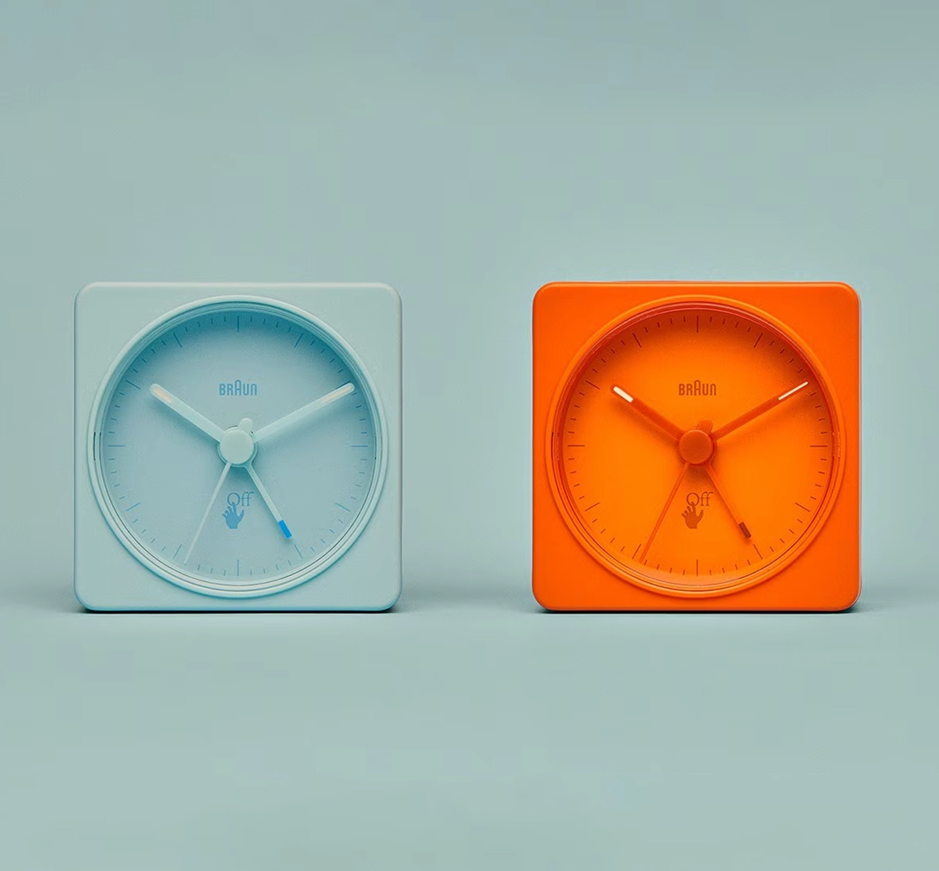 2 colourful alarm clocks on blue background