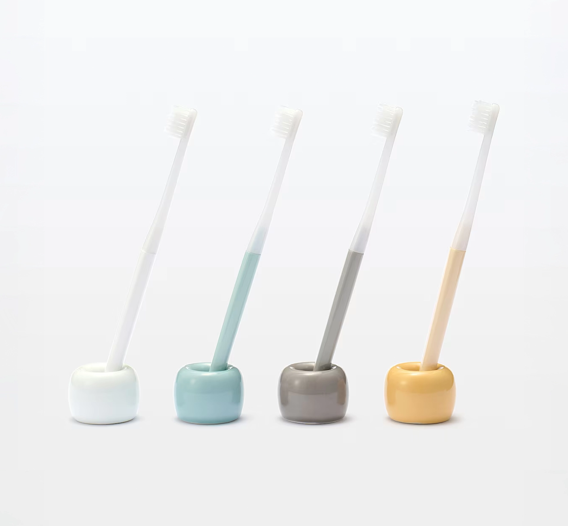 4 toothbrushes in different colours