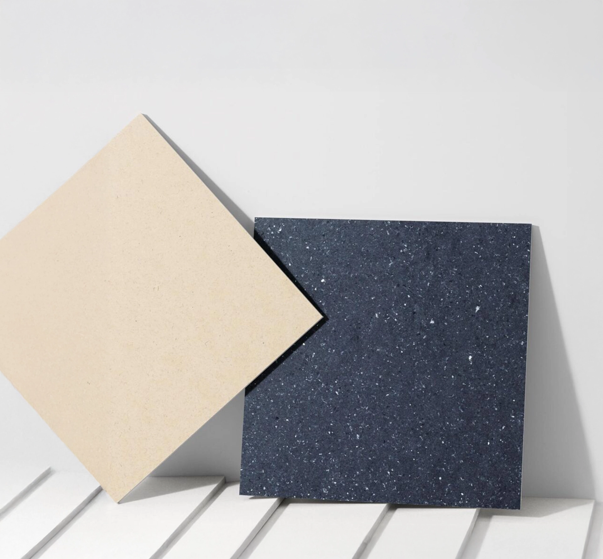 two tiles leaning against a wall