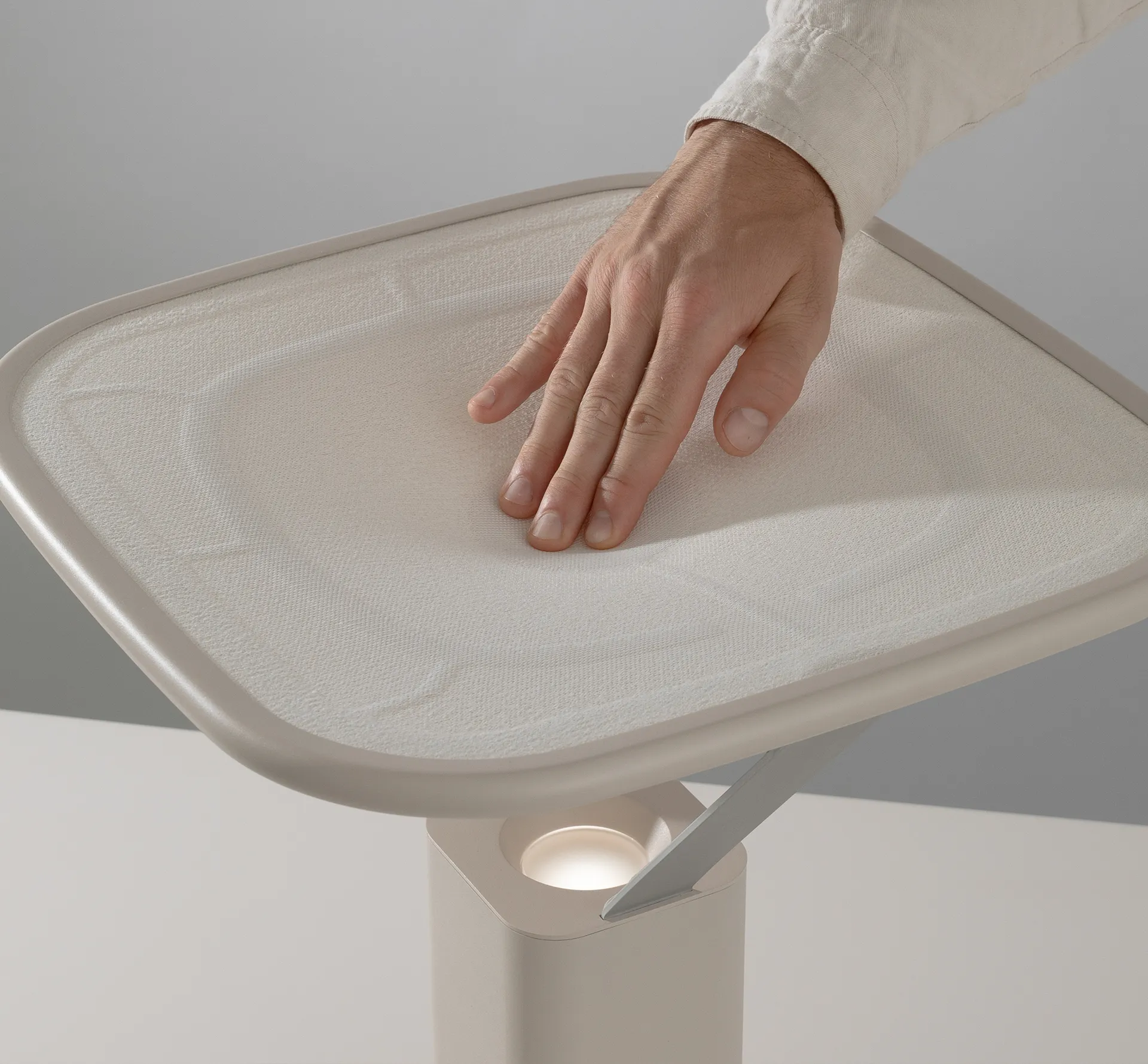 hand pressing on a fabric surface