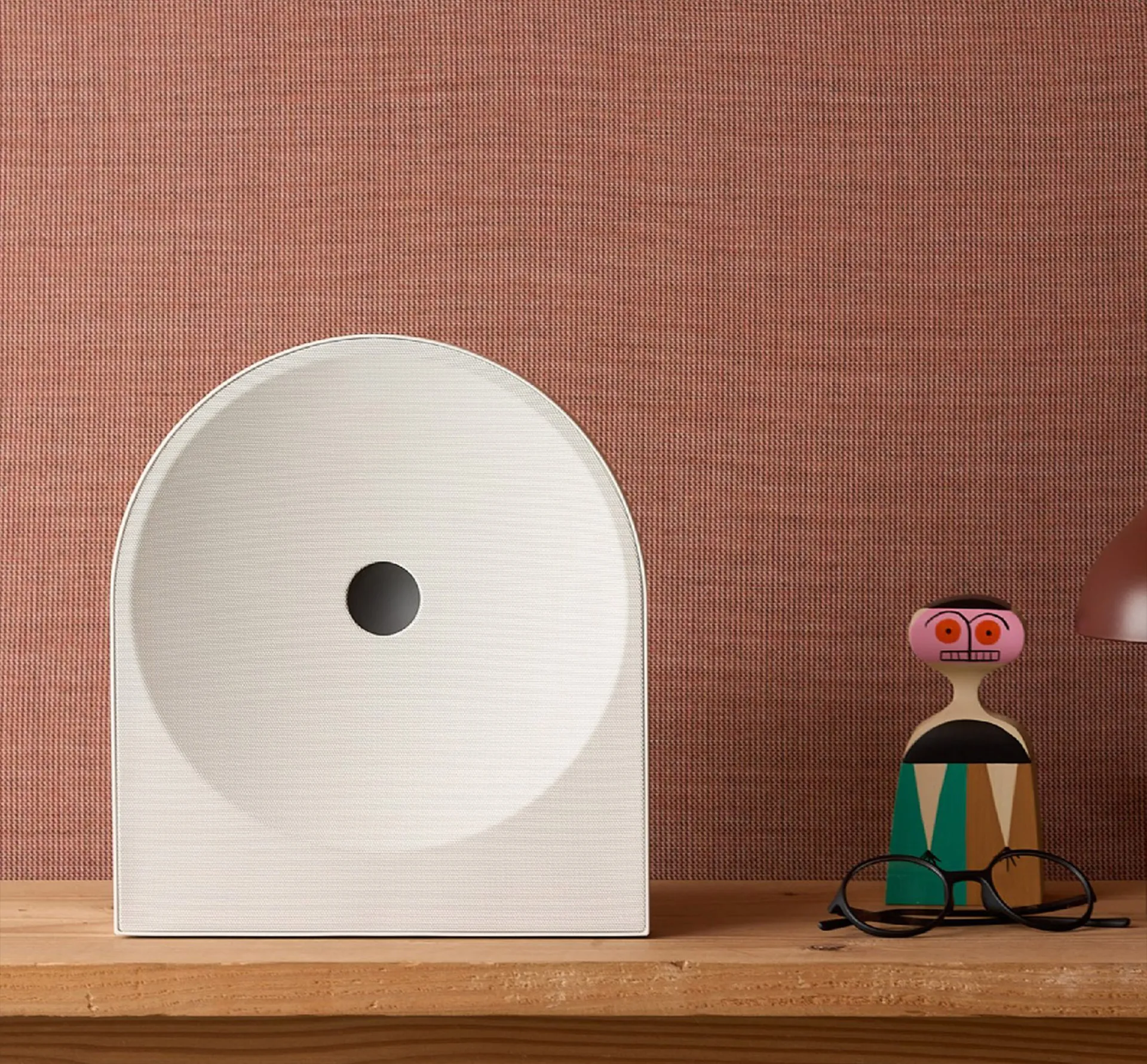 modern speaker on a wooden shelf
