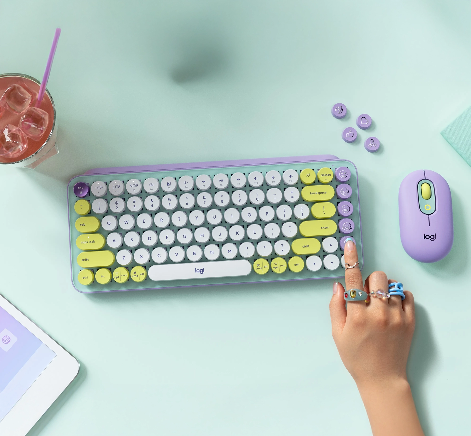 Someone pressing a button of a colourful keyboard